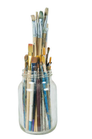 Various professional paint brushes in the transparent jar, isolated on white backgroundの写真素材