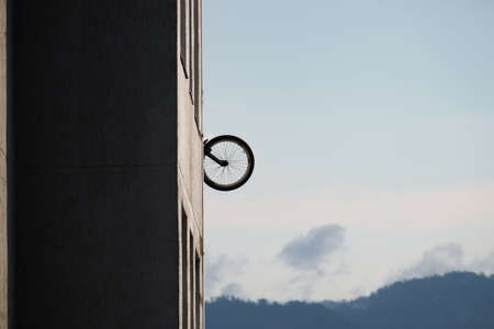 Bicycle hanging on the wall of the building
