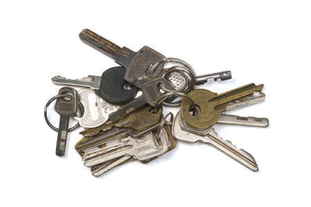 Bunch of metal keys with rings on the white surfaceの写真素材
