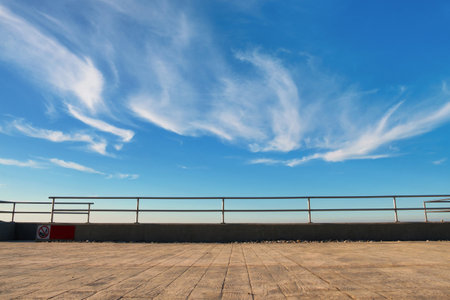 Metal barrier or railings between promenade and blue skyの写真素材