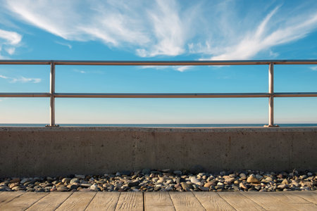 Metal barrier or raillings betveen promenade and blue seaの写真素材