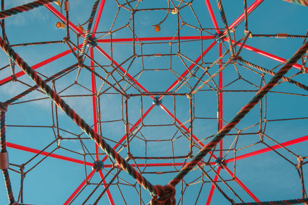 Abstract geometrical background photo of colorful ropes on blue sky backgroundの写真素材
