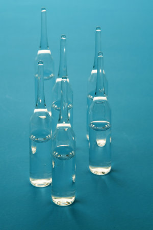 Medicine ampoules for injections on blue surface