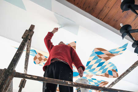 Artist painting on a ceilingの写真素材