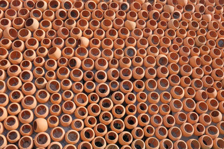 The wall made with rows of ceramic clay pots