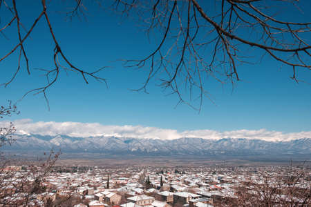 Beautiful view of Caucasus mountains from the town covered with snow