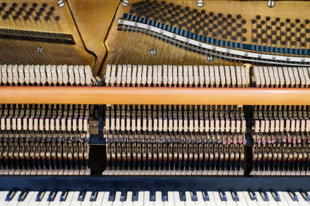 View inside of an old piano, repair and tuning of musical instrumentsの写真素材
