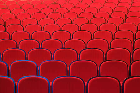 Rows of empty red chairs in concert hallの写真素材