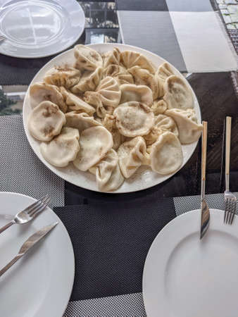 National dish of Georgian cuisine khinkali with black pepper on the tableの写真素材