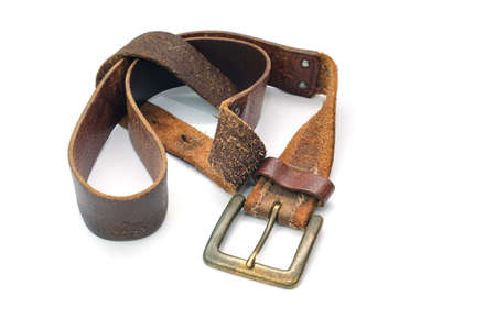 Used brown leather belt isolated on white backgroundの写真素材