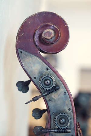 Closeup view of an old violin details of a head on a blurred background