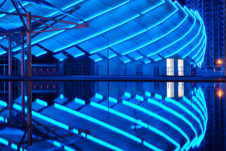 Batumi, Georgia, October, 1, 2021: Batumi Stadium, Night view of the illuminated modern building construction reflecting on a water surfaceのeditorial素材