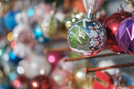 Various colorful Christmas balls with blurred baubles background, selective focusの写真素材