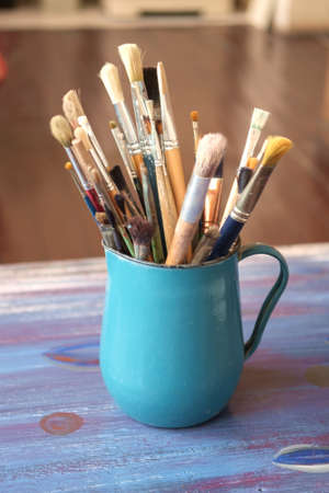 Various professional paint brushes in the blue metal jar, selective focusの写真素材