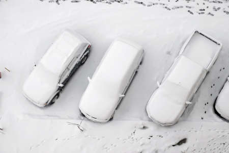 Parked cars covered with snow, top viewの写真素材