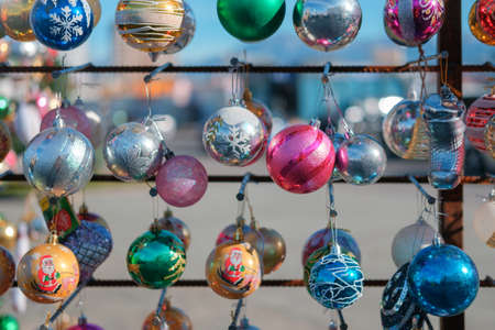 Various colorful Christmas balls on the stand on a blurred backgroundの写真素材