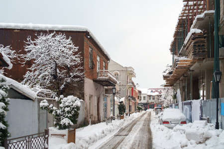 A snowy street through the old houses in the districtの写真素材