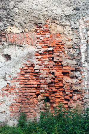 Old weathered brick and stone wall grunge backgroundの写真素材