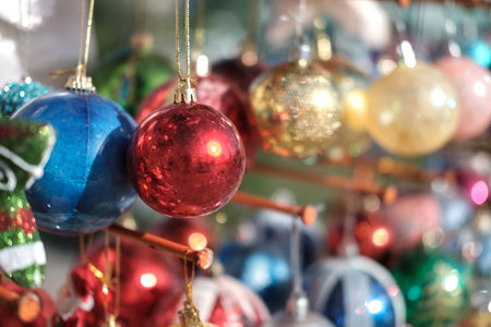 Various colorful Christmas balls with blurred baubles background, selective focusの写真素材