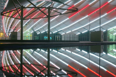 Batumi, Georgia, October, 22, 2021: Batumi Stadium, Night view of the illuminated modern building construction reflecting on a water surfaceのeditorial素材
