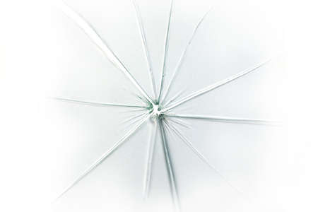 The hole in the broken and cracked glass on white background, closeupの写真素材
