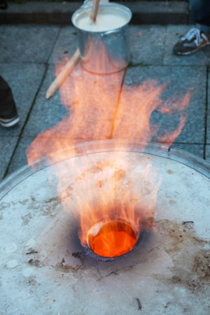 Fire flames blowing out from the hole of the metal barrelの写真素材
