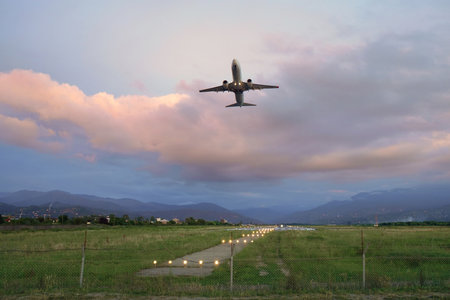 A passenger plane flying up in the cloudy sky