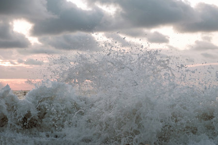 Foamy sea waves splashing, stormy cloudy background
