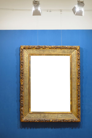 Old style vintage golden frame with empty space on the illuminated blue background. Art gallery interiorの写真素材