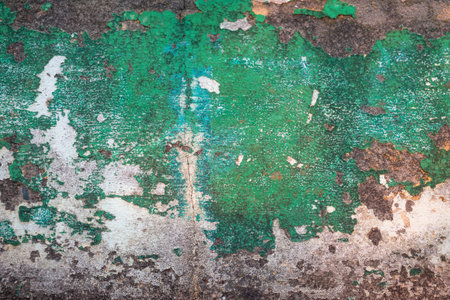 Peeling green paint on rough textured shabby wall, grunge backgroundの写真素材
