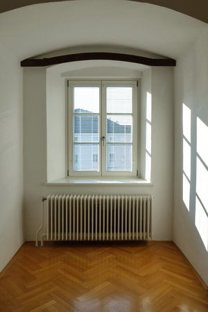 Empty interior of a old house with reflections of sunlight through the window with blindsの写真素材