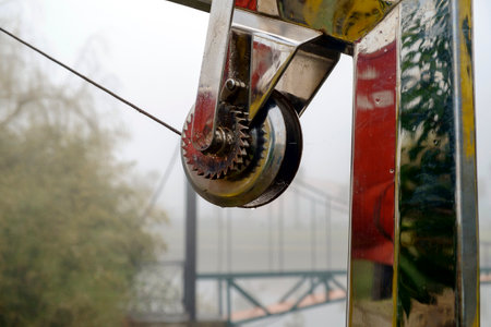 Detail of a polished steel davit or crane for boat on a blurred backgroundの写真素材