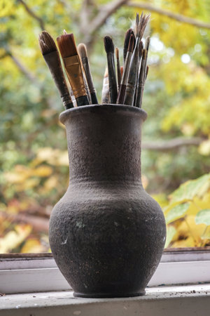 Various professional paint brushes in the clay jar, selective focusの写真素材