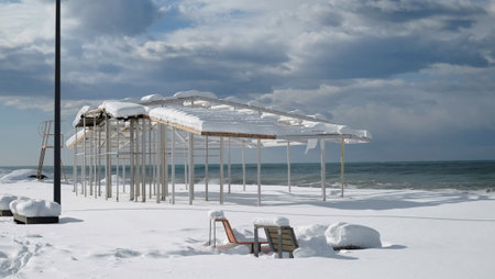 Snow covered metal construction at the beachの写真素材