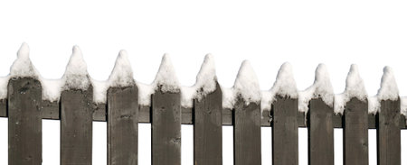 Snow covered brown wooden fence isolated on white backgroundの写真素材