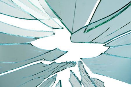 Cracked and broken glass with hole on a white backgroundの写真素材