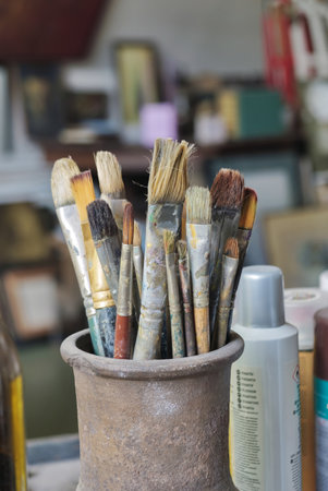 Various professional paint brushes in the clay jar at art studioの写真素材