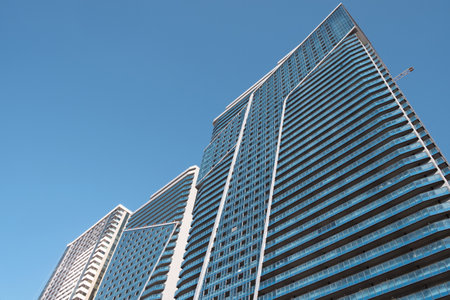 View of the windows of the skyscraper on the blue sky backgroundの写真素材