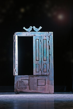 Vintage wooden rough door with peeled paint on dark background.の写真素材