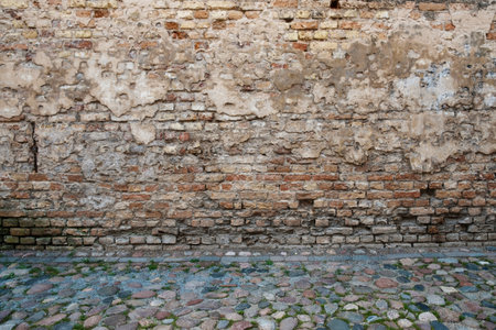 Grunge brick wall and stone pavement streetの写真素材