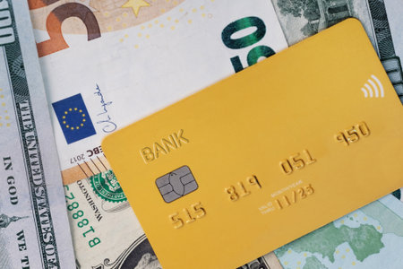 Credit card laying on top of  the cash of moneyの写真素材