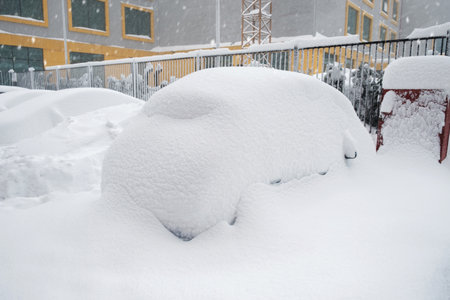 Parking lot with cars covered with fresh snow after snowfallの写真素材