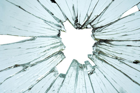Cracked and broken glass with hole on a white backgroundの写真素材