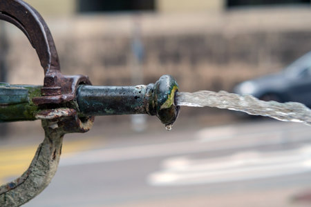 Clean water flowing from the old drinking fountain, selective focusの写真素材