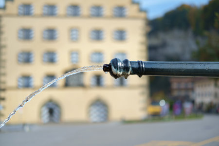 Clean water flowing from the old fountain, selective focusの写真素材