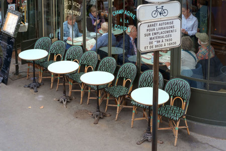 Paris, France, October 24, 2025: The exterior of a classic Parisian cafe or bistro chairs and tables spilling onto the sidewalkのeditorial素材