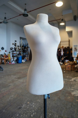 White fabric female dress form or mannequin torso with an adjustable metal standの写真素材