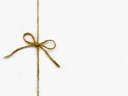 Twine tied in a bow isolated on white backgroundの写真素材
