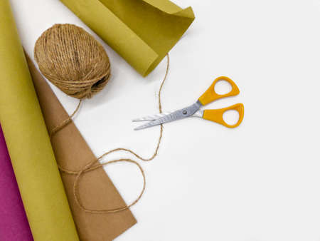 Composition of twine, kraft paper and scissors, top view.の写真素材