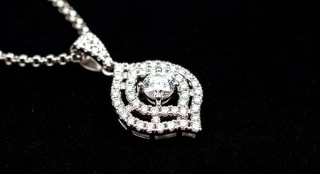 Silver jewelery on a black background in close-up shot.の素材